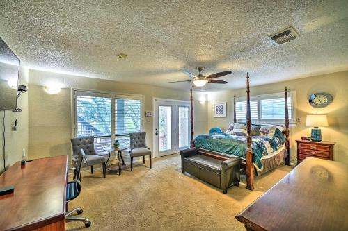 a bedroom with a bed and a desk and chairs at Relaxing Helotes Pad 7 Mi to UT at San Antonio! in San Antonio