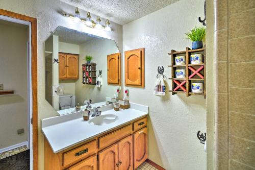 a bathroom with a sink and a mirror at Relaxing Helotes Pad 7 Mi to UT at San Antonio! in San Antonio