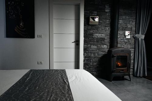 a bedroom with a bed and a wood stove at Diamond Mansion-Suite B in Had Nes