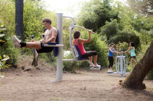 a group of people exercising on a gym at Le Esperidi Camping Ecoresort in Marina di Bibbona