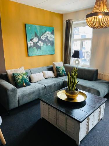 a living room with a couch and a table at Valkenhof in Valkenburg