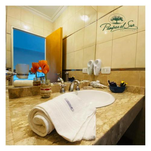 a bathroom with a sink with a towel on it at Pampas al Sur in Colorado River