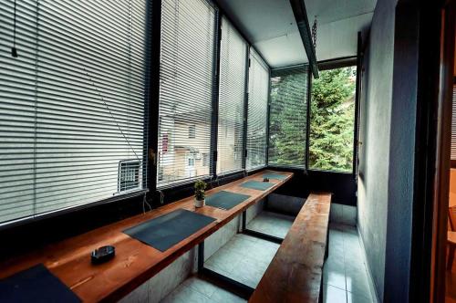 a row of sinks in a room with large windows at Town hostel in Peje