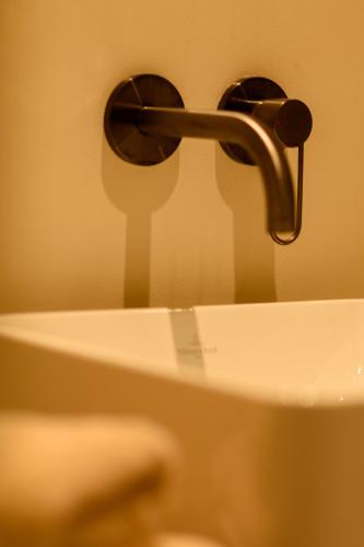 a bathroom sink with a faucet on top of it at 't Knus Gewilg in Avelgem