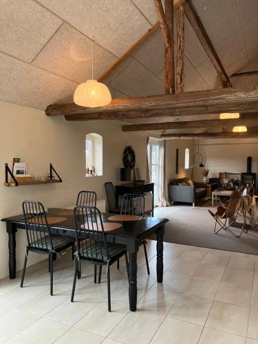 a dining room with a table and chairs and a living room at Bolding Apartments in Billund