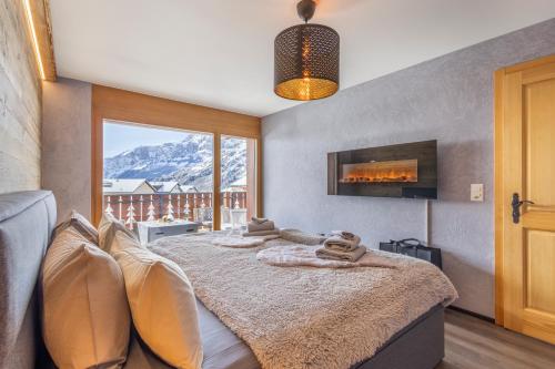a bedroom with a bed with a view of a mountain at Once Upon A Time in Leukerbad