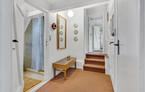 a hallway with a table and stairs in a house at Awesome Apartment In Aabenraa With Wifi in Aabenraa