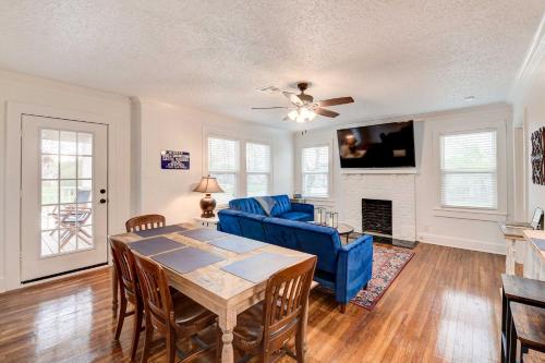 a living room with a table and a blue couch at 2 Mi to Magnolia Mkt Cozy Retreat with Shared Yard in Waco