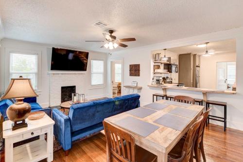 a living room with a blue couch and a table at 2 Mi to Magnolia Mkt Cozy Retreat with Shared Yard in Waco