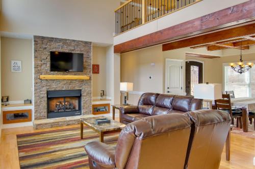 a living room with a couch and a fireplace at Stunning Nebo Lake House with Deck and Views! in Nebo