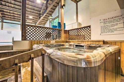 a hot tub in a room with wooden walls at Stowe Condo with Deck and Mountain Views! in Stowe