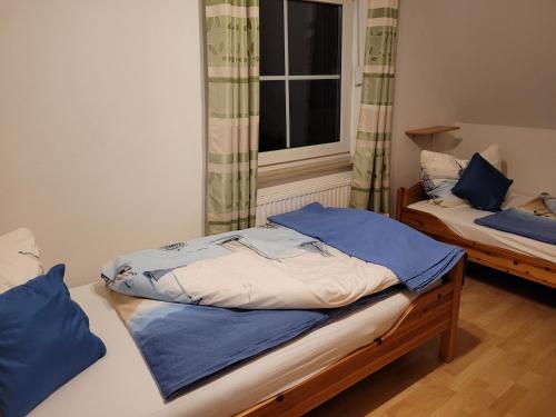 Postel nebo postele na pokoji v ubytování Ostseeträume
