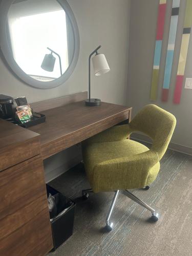 a desk and a chair with a lamp and a mirror at Hampton Inn By Hilton Kingston in Kingston