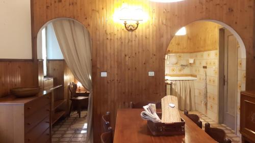 een eetkamer met een tafel en twee spiegels bij Villaggio Barilari in Minucciano