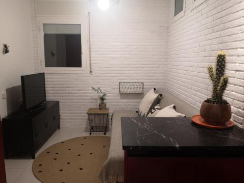 a living room with a white brick wall at Torre con vistas in Tossa de Mar