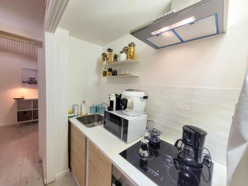 a kitchen with a counter with a coffee maker on it at Magellano Suite. Fronte Mare + Free Park + Wi-Fi in Porto Empedocle