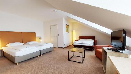 Ένα ή περισσότερα κρεβάτια σε δωμάτιο στο GHOTEL hotel & living Kiel