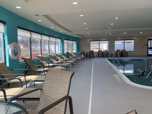 a waiting room with chairs and a swimming pool at Best Western Plus Horseheads Inn & Suites in Horseheads