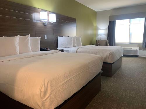 a hotel room with two beds and a window at Best Western Plus Horseheads Inn & Suites in Horseheads