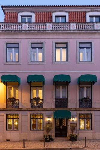 a large white building with windows and green awnings at As Janelas Verdes Inn - Lisbon Heritage Collection - Riverside in Lisbon