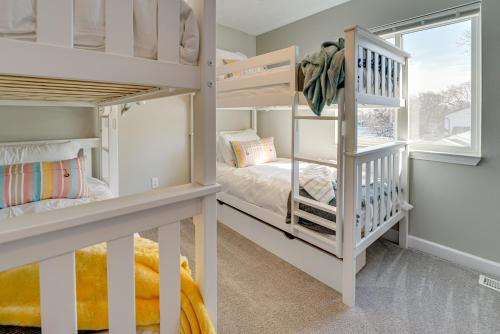 two bunk beds in a room with a window at Lakefront Home Rental with Hot Tub in White Lake! in Oxbow