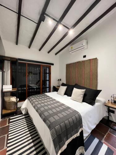 a bedroom with a large white bed in a room at Casa Medallo in Medellín