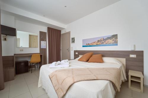 a hotel room with a bed with towels on it at Firmafede Guest House in Sarzana