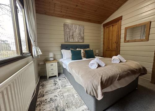 a bedroom with a large bed in a room at Sherwood Castle Holiday Forest in Edwinstowe