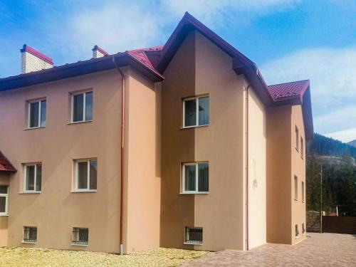 a house in the mountains on a sunny day at Den House in Myslovka