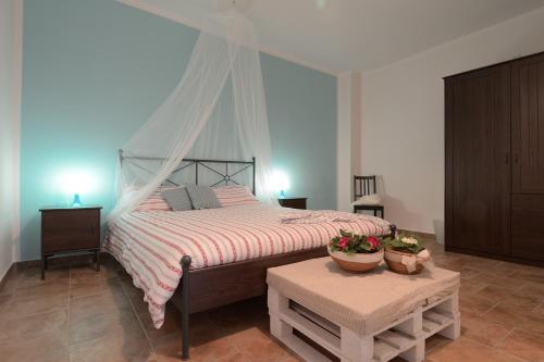 a bedroom with a bed and a table with flowers on it at Casetta Don Carlino in Campomarino