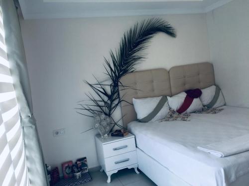 a bedroom with a bed with a plant above it at Orka world in Fethiye