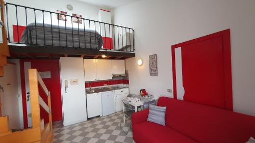 a living room with a red couch and a loft at Appartamenti Adriana Sirmione in Sirmione