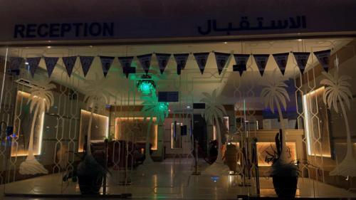 a display window of a fashion store with a green light at Jeddah Shadows Hotel in Jeddah