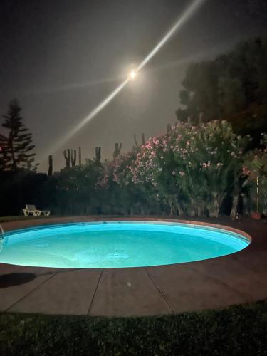 a swimming pool at night with a light at Vila sol in Armação de Pêra