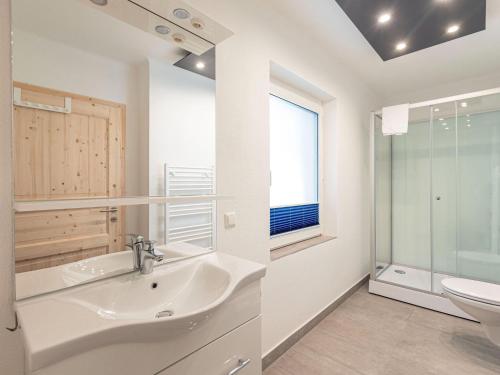 a bathroom with a sink and a toilet at Apartment Seemauer am Erzberg in Eisenerz