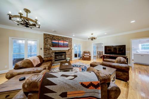 a living room with leather furniture and a fireplace at Riverside Gardens in Tiger