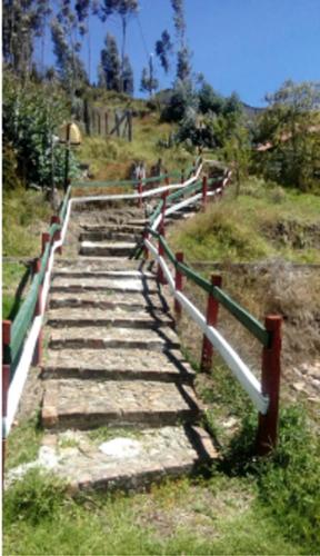 a pathway with a fence on a hill at Hotel MAXIRUMA - Villa TAMAUKA in Iza