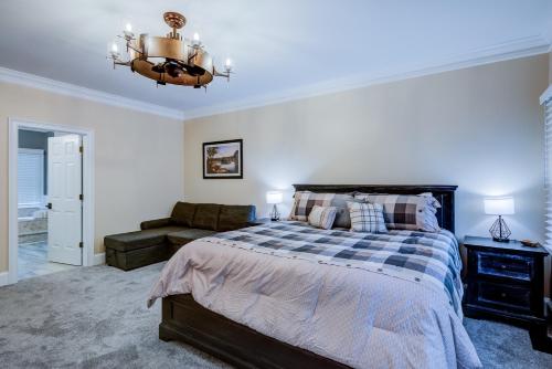 a bedroom with a bed and a couch at Riverside Gardens in Tiger