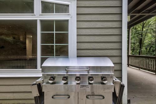 a grill sitting outside of a house on a porch at Riverside Gardens in Tiger