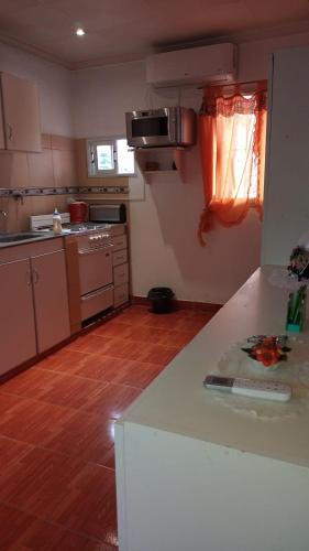 a kitchen with a white counter top in a room at Aires del Cerro in Yerba Buena
