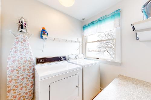 uma lavandaria com uma máquina de lavar roupa e uma janela em Tideview em Owls Head