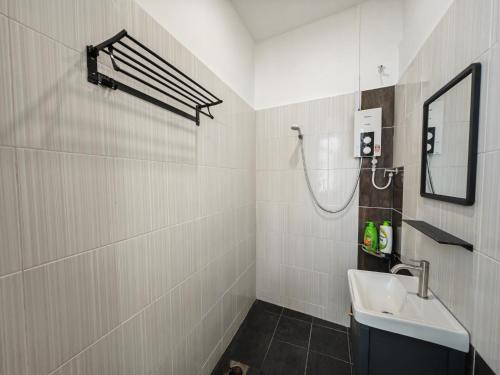 a bathroom with a sink and a mirror at 4min walk to Jonker/Town 16 ~20 pax Dart & Snooker in Melaka