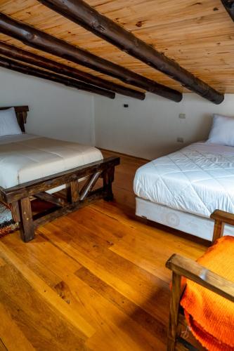 Postel nebo postele na pokoji v ubytování Hacienda Turistica Intihuatana