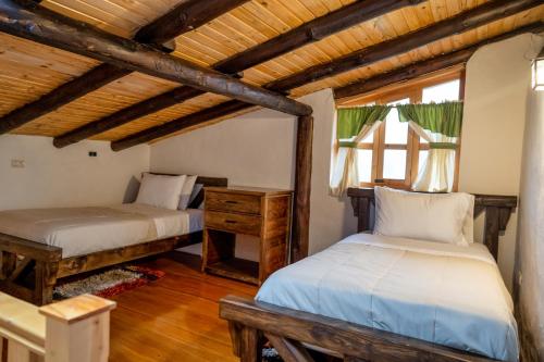 Postel nebo postele na pokoji v ubytování Hacienda Turistica Intihuatana