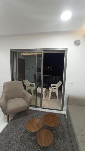a living room with a couch and a chair at Sublime appartement le Palace Hammamet Nord Mrezga - Family only in Hammamet