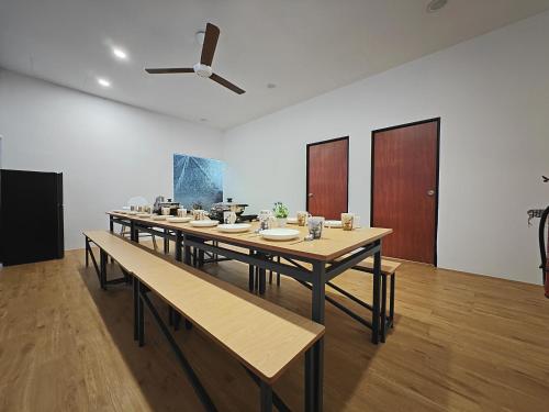 a large room with tables and a ceiling fan at KTV, Dart & Snooker 4BR 16-20pax 4min walk to Jonker & Town in Melaka