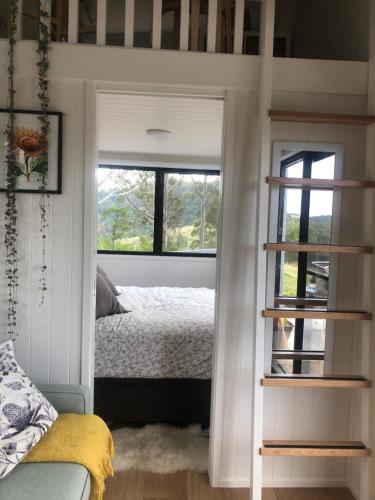 a bedroom with a bed and a window at Tiny Nerak in Nethercote