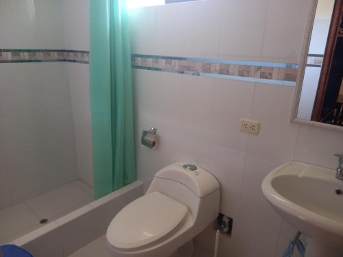 a bathroom with a toilet and a sink at Villa Concepción Lodge in Anta