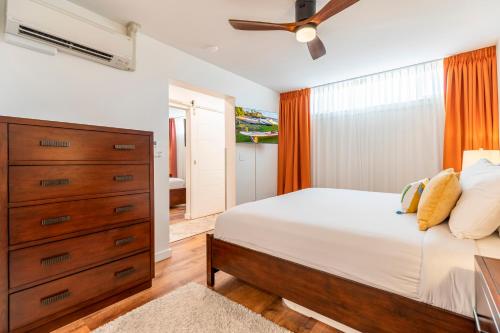 a bedroom with a large bed and a dresser at RARE Upscale 2BR 2BA Kuau Paia - Walk to Beach! in Paia