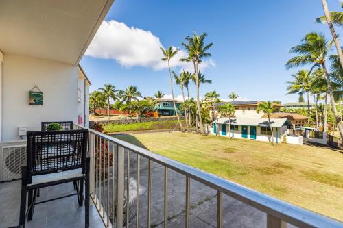 a view from the balcony of a house with a yard at RARE Upscale 2BR 2BA Kuau Paia - Walk to Beach! in Paia